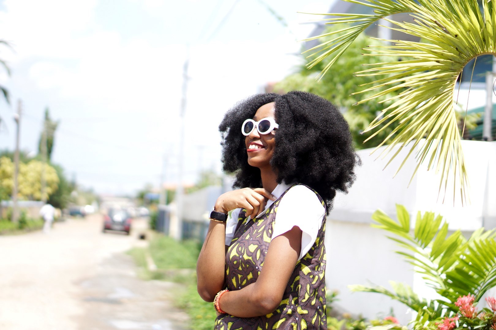 Nigeria fashion blogger Cassie daves in white sunglasses Kurt cobain and afro crochet wig by nappy haired wigs.