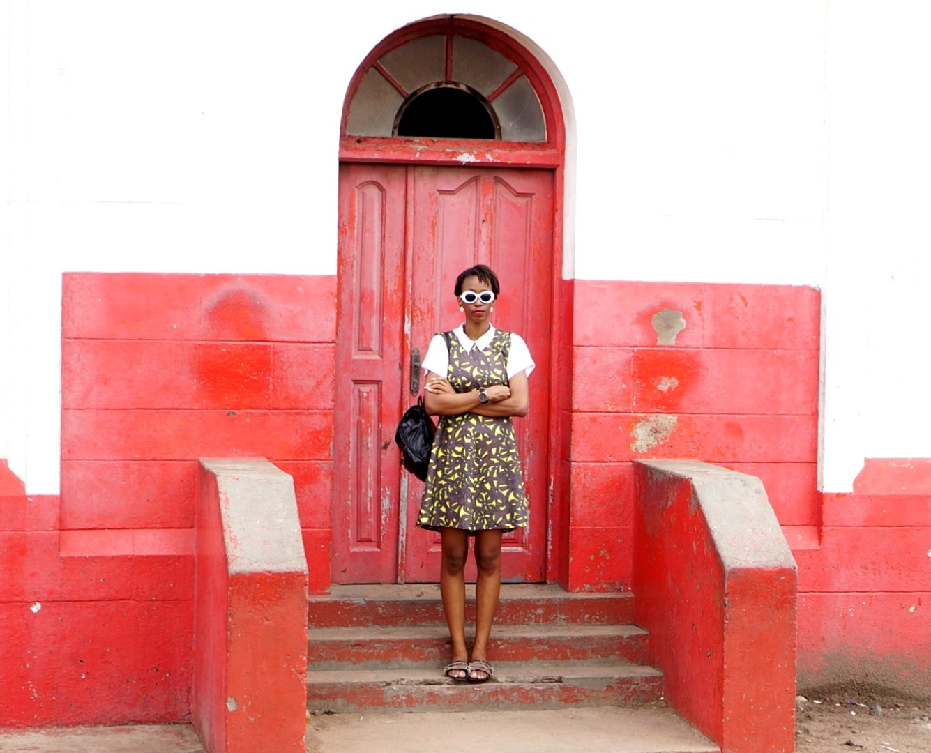 Nigerian blogger Cassie Daves standing in front of the Jamestown light house Accra