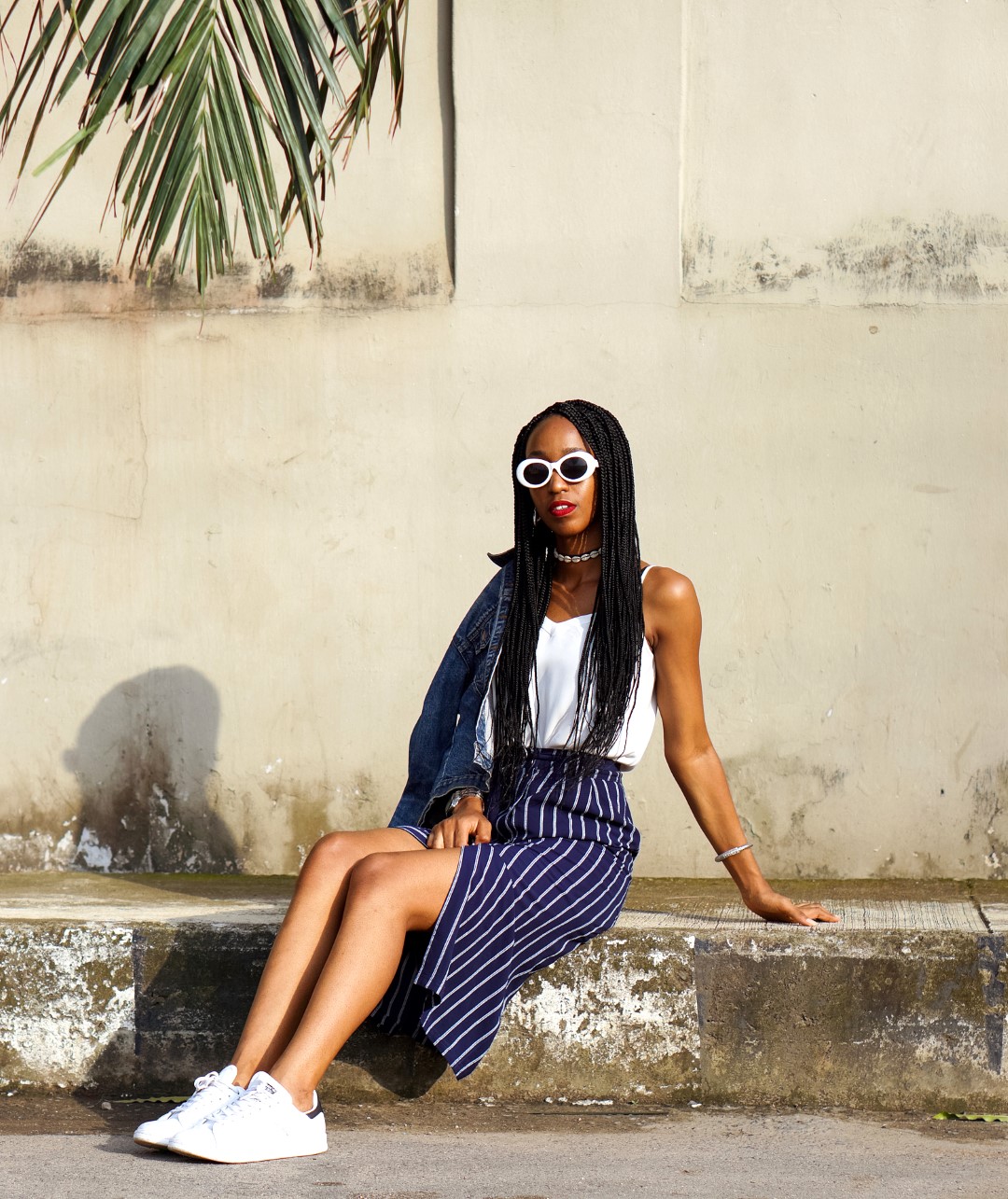 Nigerian blogger cassie daves styling the skirt and sneakers trend