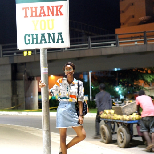 Nigerian blogger Cassie Daves standing at a sign post in Accra Ghana, Things to do In Accra