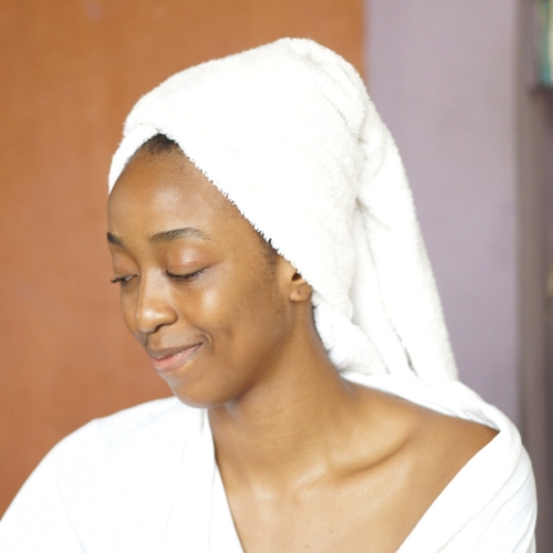Blogger Cassie Daves in a white robe and towel turban